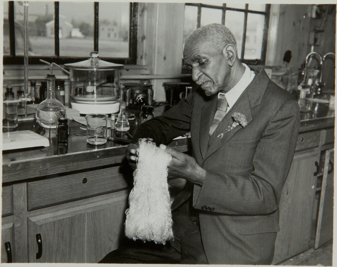 A men sitting in a lab and holding fibers in his hands